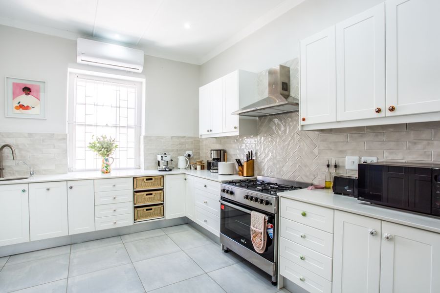 White kitchen with gas stove and air-conditioning